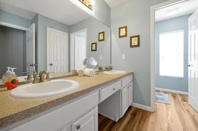 a bathroom with two sinks and a large mirror at 6 Bedroom Villa located in Windsor Hills 3 miles to Disney Free Heated Pool & Spa Game Room with PS5! in Orlando