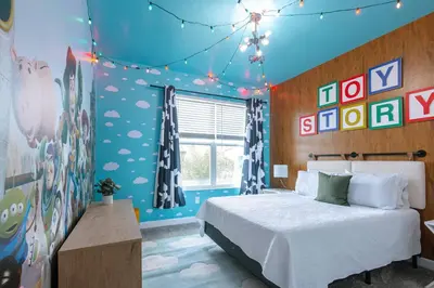 a bedroom with a bed and some signs on the wall at Storey Lake Resort 515 - Hosted by Top Villas in Kissimmee