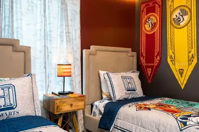 a bedroom with two beds and a lamp on a night stand at Last Minute Disney Private Pool Themed Bedrooms. Book Now SLR516 in Kissimmee