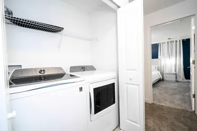 a white kitchen with a stove top oven next to a door at Last Minute Disney Private Pool Themed Bedrooms. Book Now SLR516 in Kissimmee