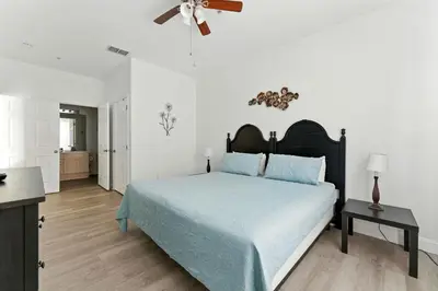 a bedroom with a bed and a ceiling fan at Last Minute Disney Luxury Condo with Balcony. Book Now WP77 in Orlando