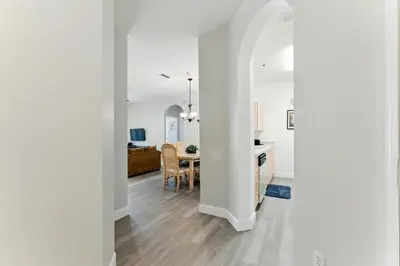 a kitchen and dining room with white walls and a table at Last Minute Disney Luxury Condo with Balcony. Book Now WP77 in Orlando