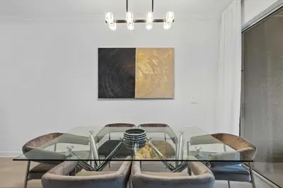 a dining room with a glass table and chairs at Storey Lake Resort 510 - Hosted by Top Villas in Kissimmee