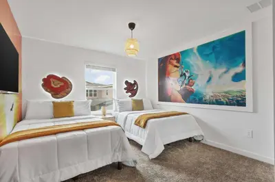 two beds in a white room with a painting on the wall at Storey Lake Resort 510 - Hosted by Top Villas in Kissimmee