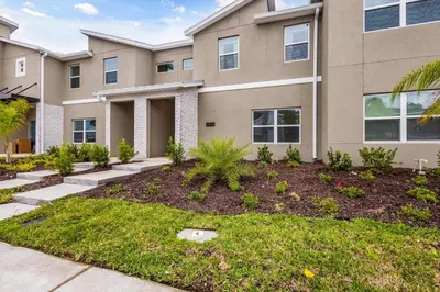 a house with a landscaping in front of it at Storey Lake Resort 510 - Hosted by Top Villas in Kissimmee