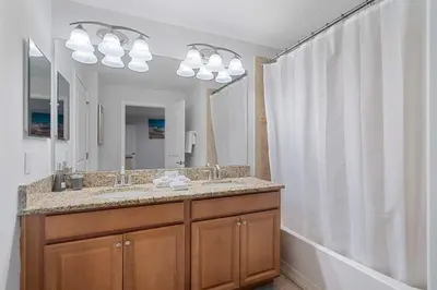 a bathroom with a sink and a large mirror at Storey Lake Resort 511 - Hosted by Top Villas in Kissimmee