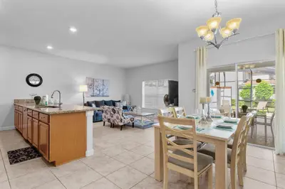 a kitchen and living room with a table and a dining room at Storey Lake Resort 511 - Hosted by Top Villas in Kissimmee