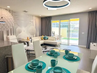 a kitchen and living room with a table and chairs at TR1435RC - 3BR - Sleeps 8 in Orlando