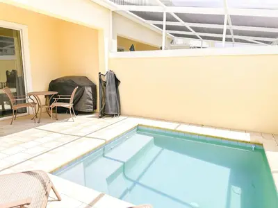 a swimming pool with a patio and a table and chairs at TR1435RC - 3BR - Sleeps 8 in Orlando