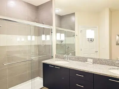 a bathroom with two sinks and a glass shower at TR1435RC - 3BR - Sleeps 8 in Orlando