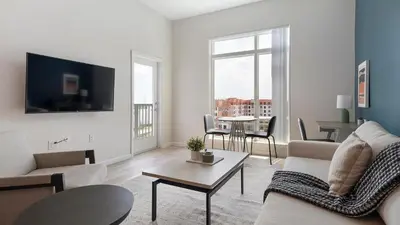 a living room with a couch and a table at Landing Incredible 1BD Gym Clubhouse in Orlando