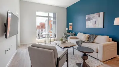 a living room with a couch and a table at Landing Incredible 1BD Gym Clubhouse in Orlando