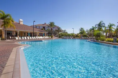 a large swimming pool with chairs in a resort at Magnificent 2 Bedroom Apt Vista Cay Resort 107 in Orlando