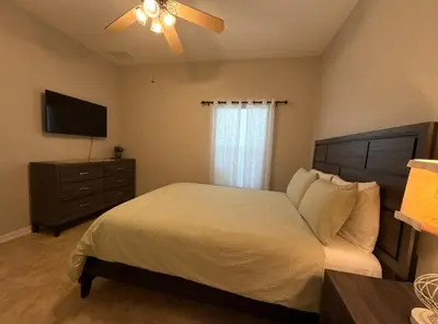 a bedroom with a bed and a ceiling fan at Family & Group Haven-Resort Style Living-Near Disney in Kissimmee
