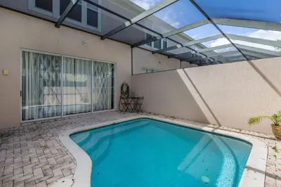 an indoor swimming pool with a glass roof at Amazing 3BDR House with pool in Kissimmee