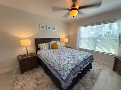 a bedroom with a bed and a ceiling fan at The Windsor Hideaway in Orlando