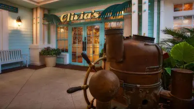 a restaurant with an old fashioned machine in front of a building at Disney's Old Key West Resort in Orlando