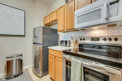 a kitchen with stainless steel appliances and wooden cabinets at 4 Mi to Disney Family-Friendly Resort Getaway! in Orlando