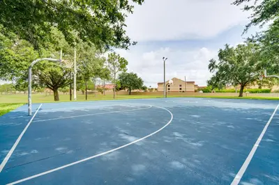 an empty basketball court in a park with trees at 4 Mi to Disney Family-Friendly Resort Getaway! in Orlando