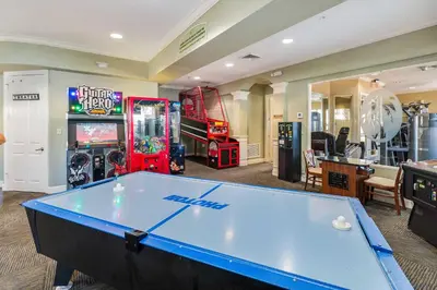 a pool table in a room with arcade games at 4 Mi to Disney Family-Friendly Resort Getaway! in Orlando