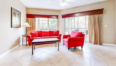 a living room with red furniture and windows at Worldquest Resort Luxurious Pet Friendly Condo in Orlando