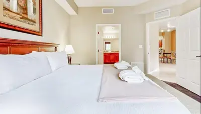 a bedroom with a white bed with two towels on it at Worldquest Resort Luxurious Pet Friendly Condo in Orlando