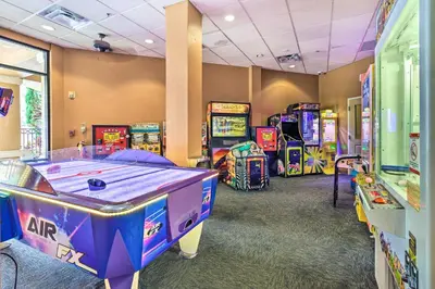 a row of arcade games in a room at Poolside Bliss and Theme Park Thrills Orlando Oasis in Orlando