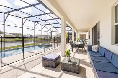 a conservatory with a view of a pool at Sleeps 36 | 15 Bedroom! Theater! Resort! POOL! in Kissimmee