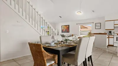 a dining room with a black table and chairs at Upstay 3BR Family-Friendly Stylish Retreat w Patio in Kissimmee