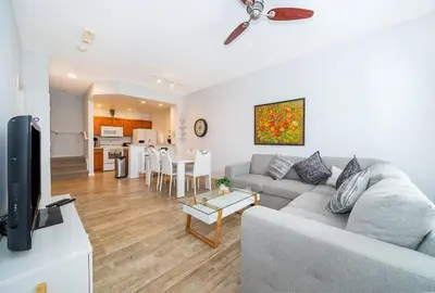 a living room with a couch and a table at Charming 3BrTownhome near Disney in Kissimmee