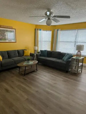 a living room with a couch and a table at Bright Condo near Disney and Universal in Kissimmee