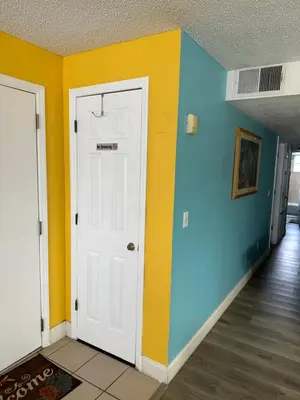 a room with blue and yellow walls and a door at Bright Condo near Disney and Universal in Kissimmee