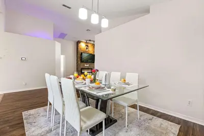 a dining room with a glass table and white chairs at Residentas Indian Creek in Kissimmee