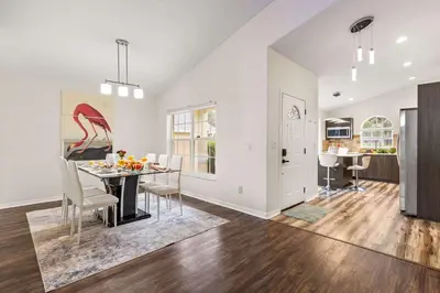 a dining room and kitchen with a table and chairs at Residentas Indian Creek in Kissimmee