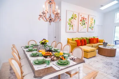 a dining room with a table with food on it at Residentas Indian Creek in Kissimmee