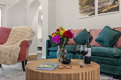 a living room with a couch and a table with flowers at Residentas Indian Creek in Kissimmee