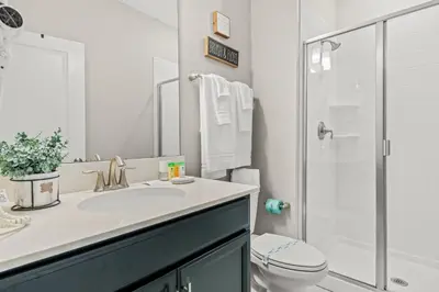 a bathroom with a sink and a toilet and a shower at 4BR Pool Home Ideal for Families in Kissimmee
