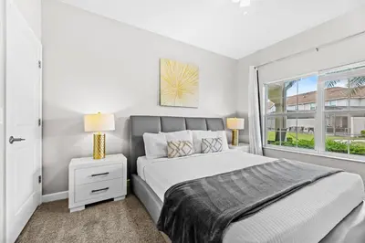 a bedroom with a bed and a window at Private Pool 4BR Home in Orlando in Kissimmee