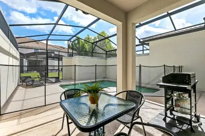 a patio with a glass table and a piano at Private Pool 4BR Home in Orlando in Kissimmee
