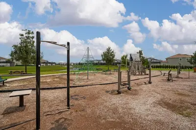an empty park with a playground with swings at Private Pool 4BR Home in Orlando in Kissimmee