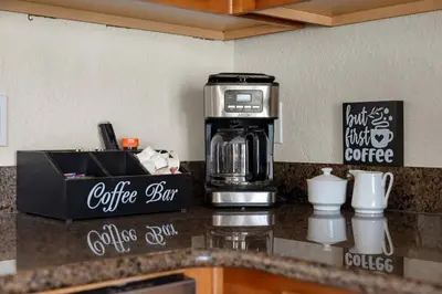 a coffeemaker on a kitchen counter with a coffee maker at Epic Disney Themehouse in Windsor (ADA option) in Orlando