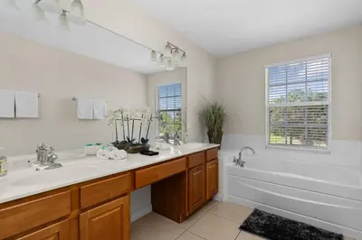a bathroom with a tub and a sink and a tub and a bath tub at Epic Disney Themehouse in Windsor (ADA option) in Orlando