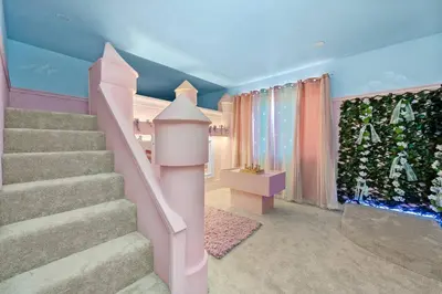 a staircase in a room with pink and blue walls at Epic Disney Themehouse in Windsor (ADA option) in Orlando