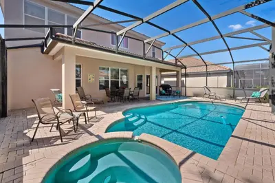 a swimming pool with a patio and a house at Epic Disney Themehouse in Windsor (ADA option) in Orlando
