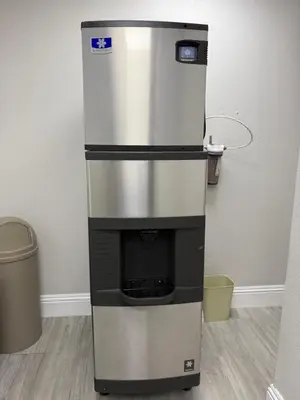 a stainless steel refrigerator sitting next to a trash can at 110 - Next to Disney - Pool in Orlando