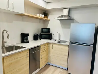 a kitchen with a refrigerator and a microwave at Condo near Epic & Universal,free parking & Netflix in Orlando