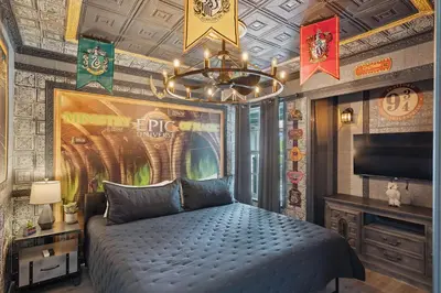 a bedroom with a bed and a poster on the wall at 2022 Royal Bay #94 in Kissimmee
