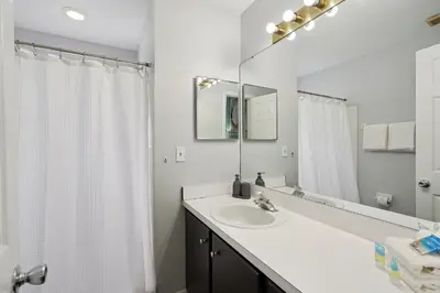 a white bathroom with a sink and a mirror at 2022 Royal Bay #94 in Kissimmee