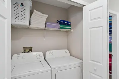 a laundry room with two washing machines and towels at 2022 Royal Bay #94 in Kissimmee