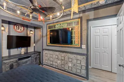 a living room with a ceiling fan and a flat screen tv at 2022 Royal Bay #94 in Kissimmee